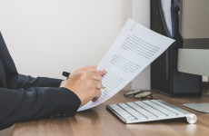Business woman reading and checking document paper on her working space